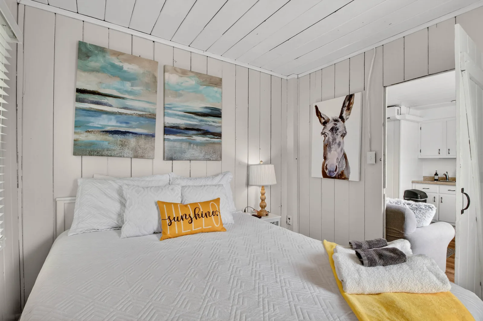 Cabin 9 bedroom with donkey portrait and view to kitchen