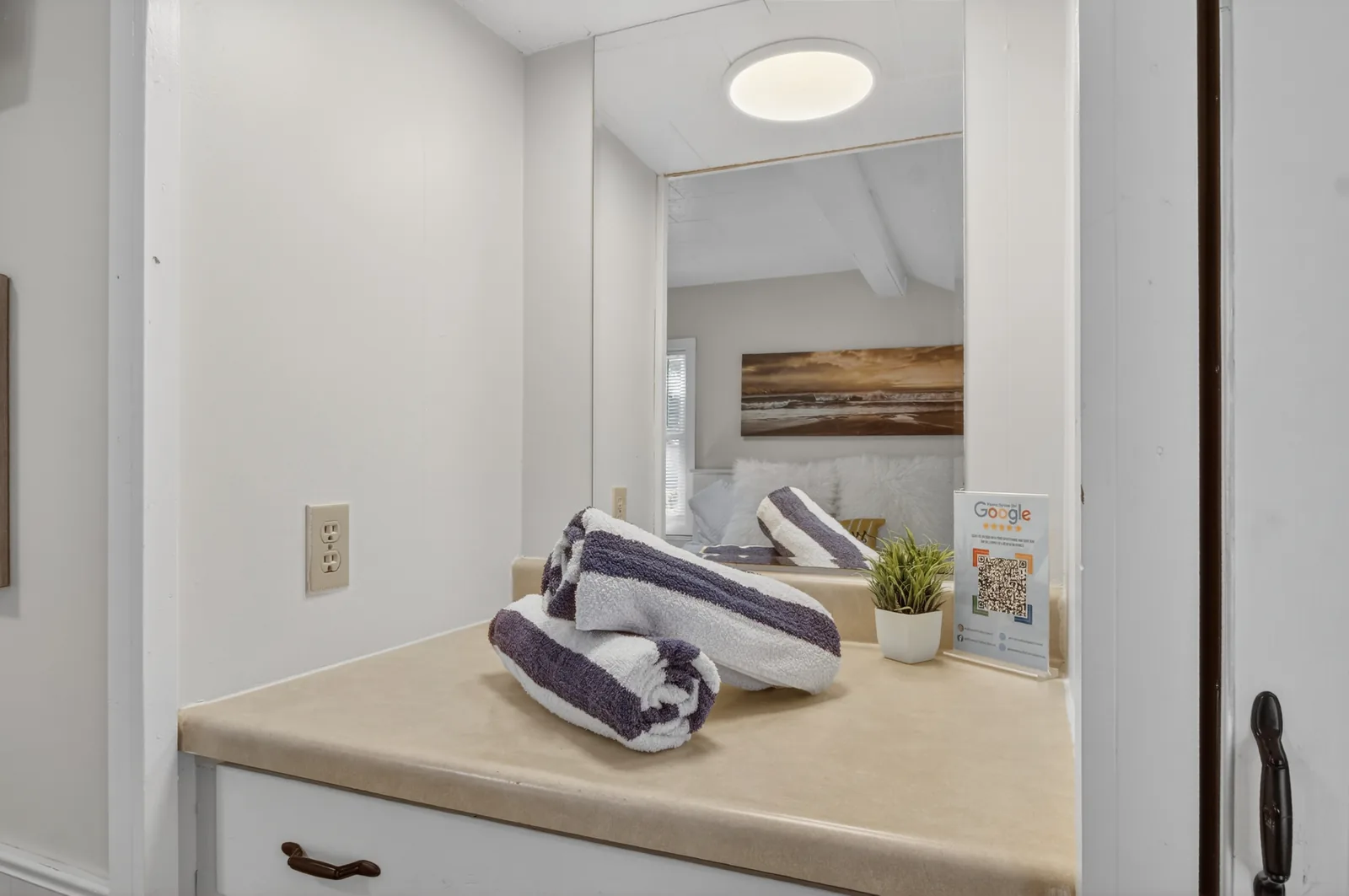Cabin 7 vanity with fresh striped towels and mirror