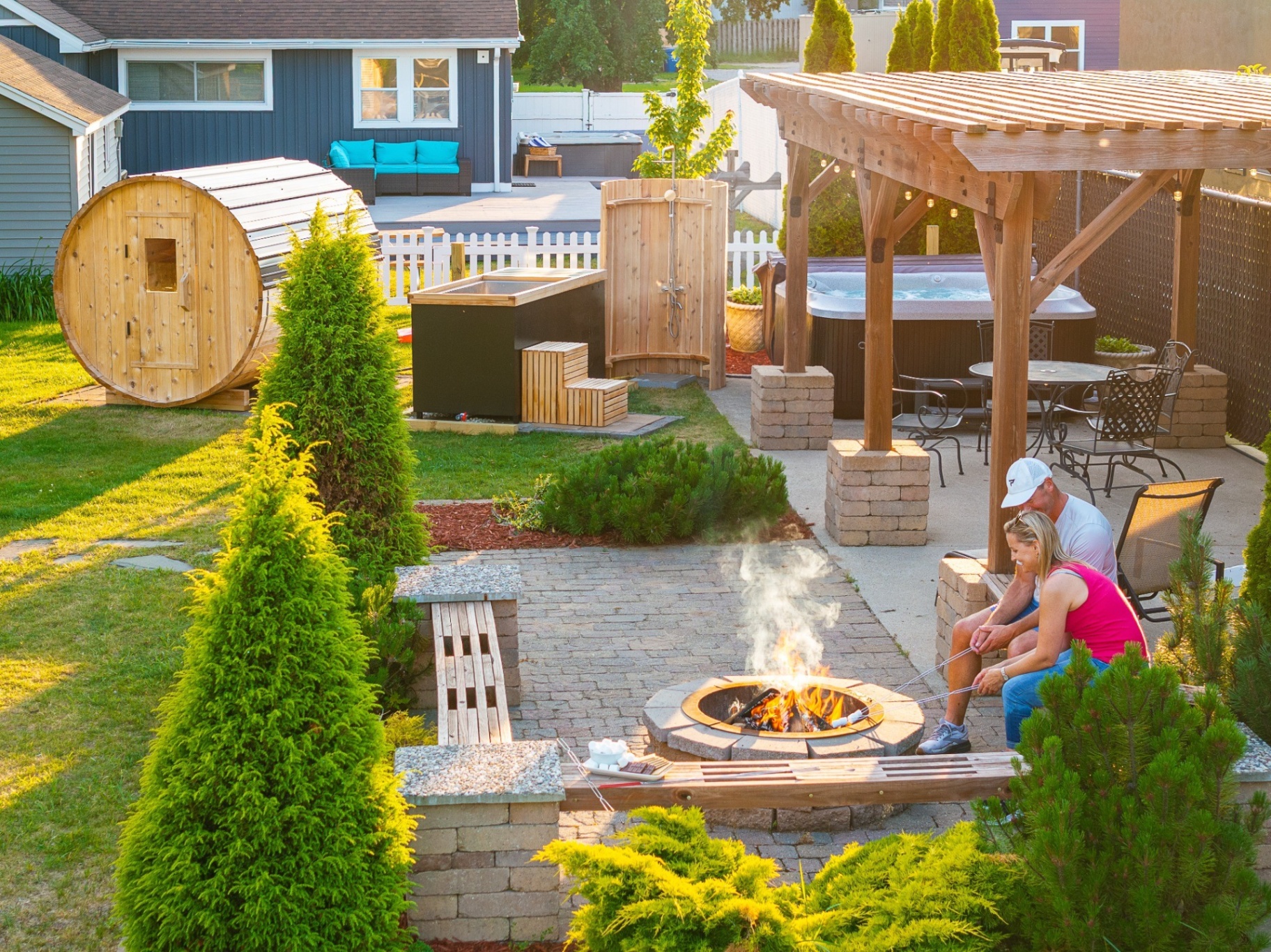 Couple relaxing by the fire pit at sunset